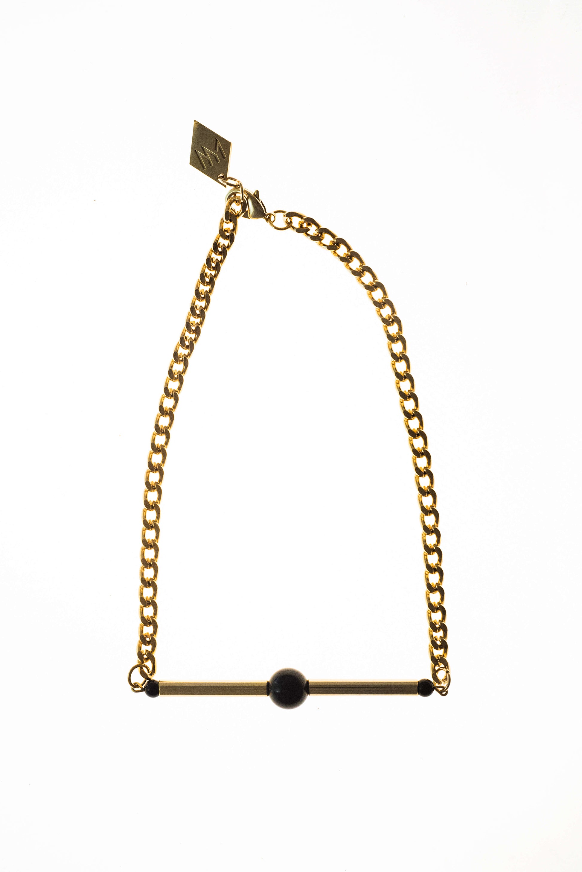 Line necklace made of hand-cut and 24K gold-plated brass, onyx and 24K gold-plated metal components.