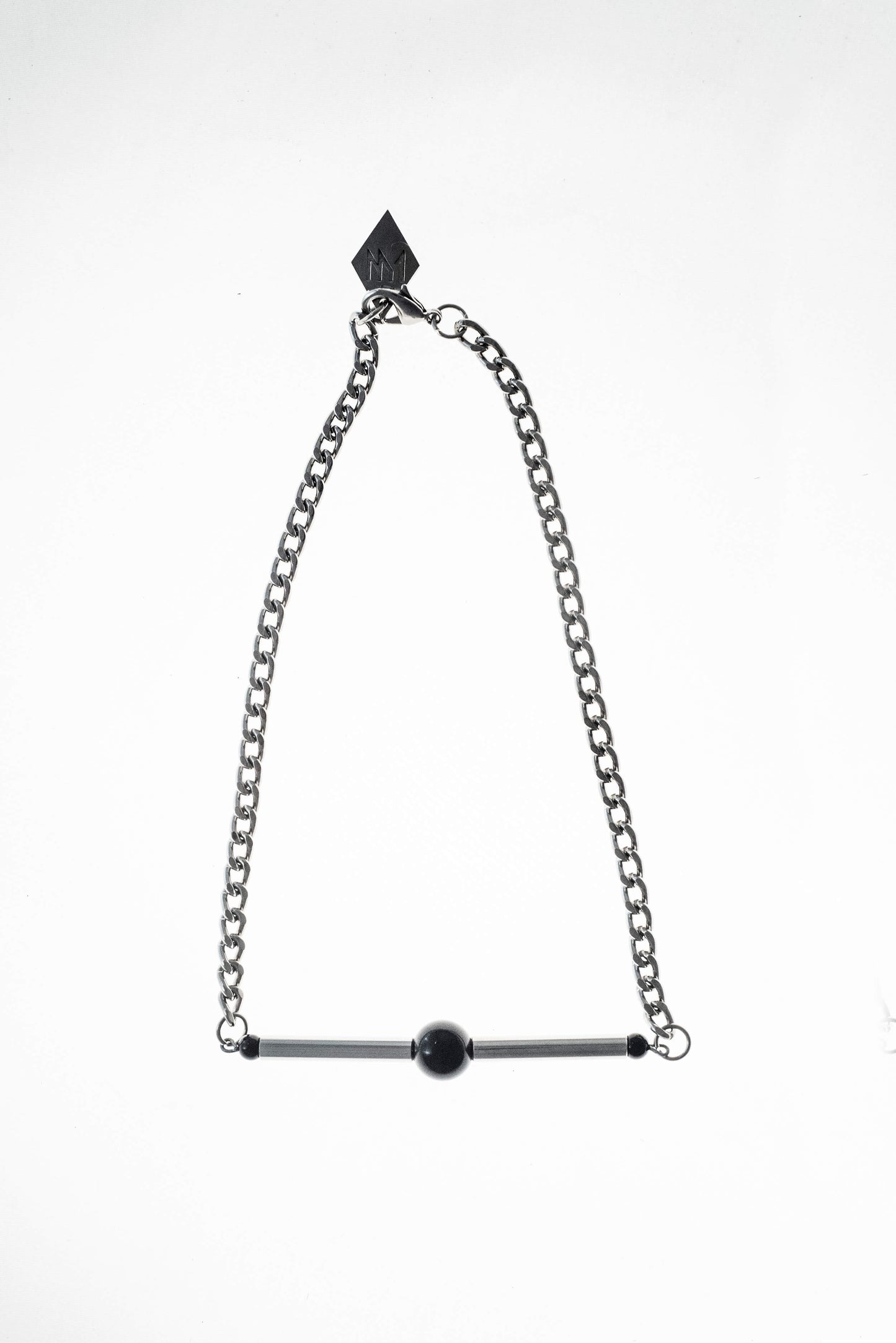 Line necklace made of hand-cut and galvanized brass, onyx and galvanized metal components.