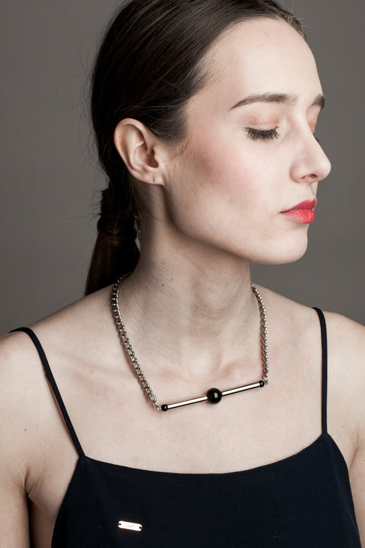 Line necklace made of hand-cut and galvanized brass, onyx and galvanized metal components.