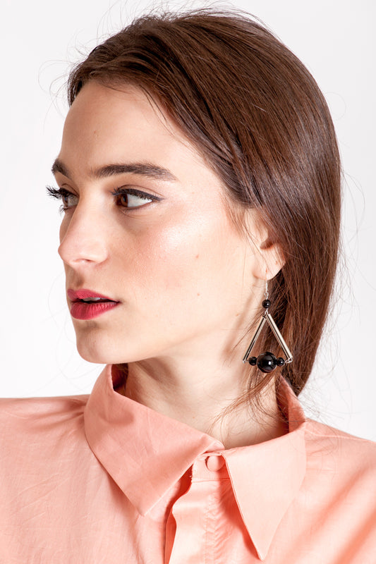 The triangle earrings are made of hand-cut, hand polished and galvanized brass, onyx and sterling silver. 