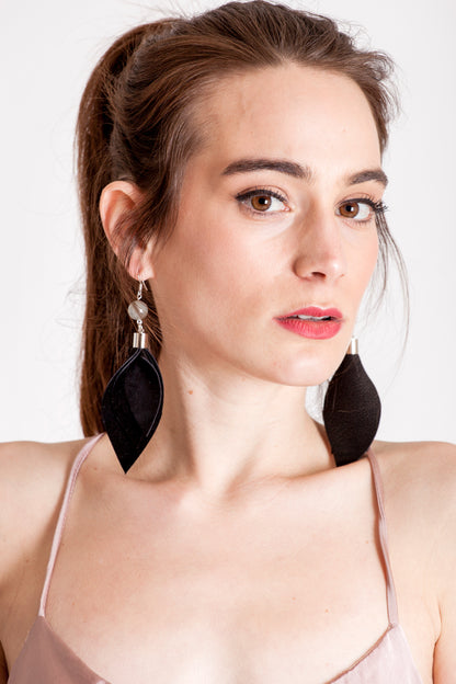 Leaf earrings made of hand-cut black leather, galvanized brass, rutilated quartz and sterling silver.