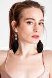 Leaf earrings made of hand-cut black leather, galvanized brass, rutilated quartz and sterling silver.