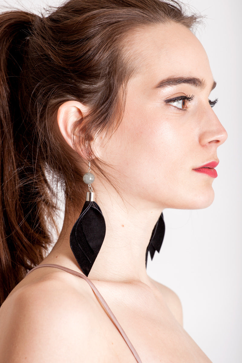 Leaf earrings made of hand-cut black leather, galvanized brass, rutilated quartz and sterling silver.