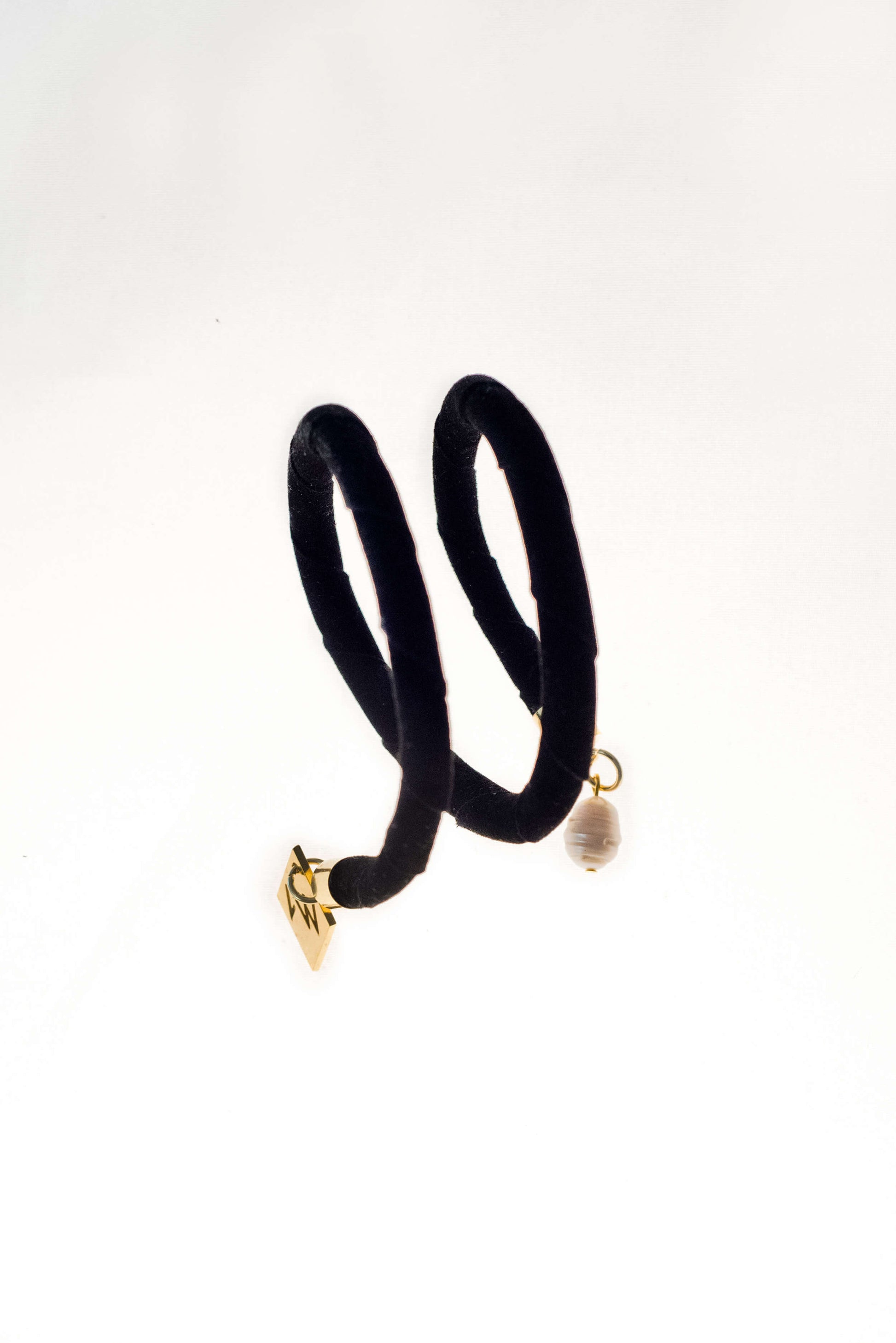 This sculptural cuff is made of finest sheep napa and 24K gold plated brass elements and freshwater pearls.