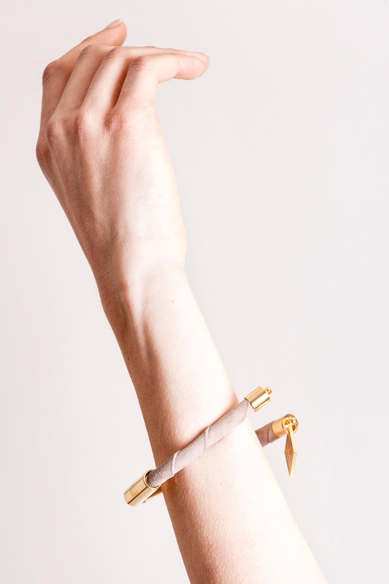 Triangle cuff made of suede and hand-cut, hand polished and galvanized brass.