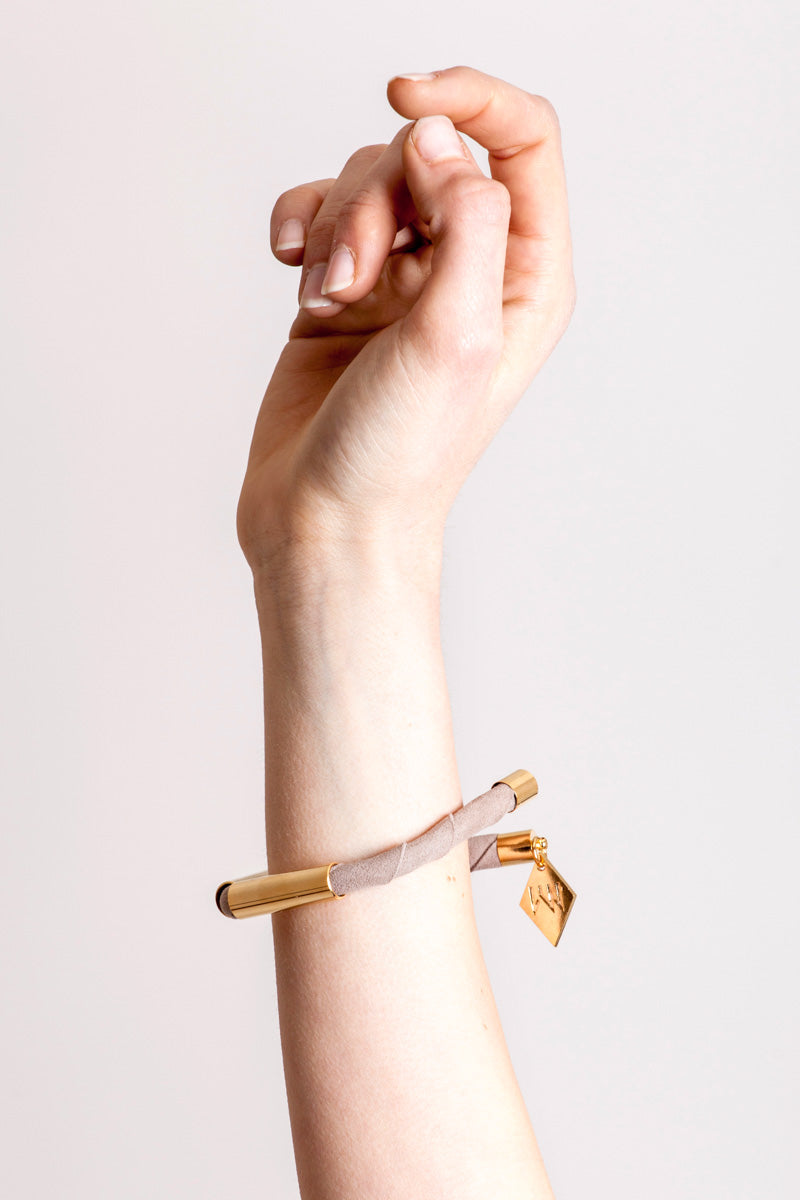 Triangle cuff made of suede and hand-cut, hand polished and galvanized brass.