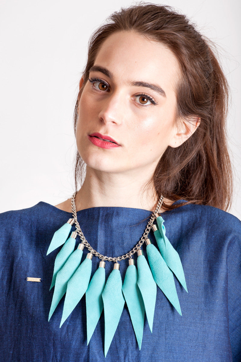 Wild child necklace in turquoise / silver features leather spikes with galvanized brass and metal components.
