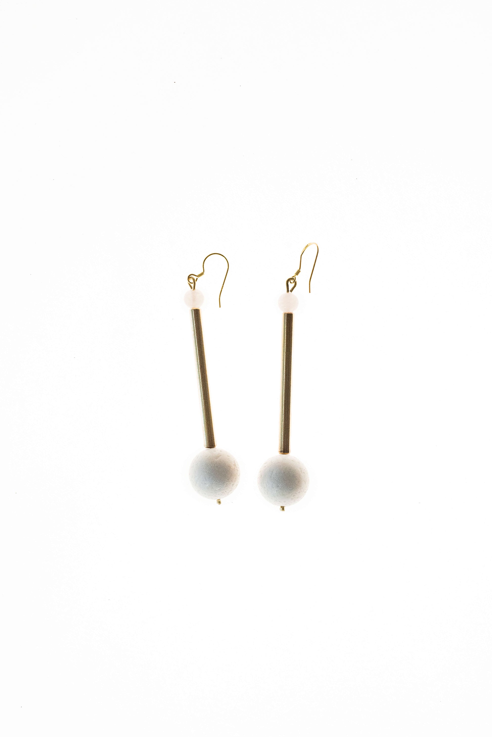 Earrings made of hand-cut, hand-polished and 24K gold-plated brass, white coral, rose quartz and gold plated sterling silver.