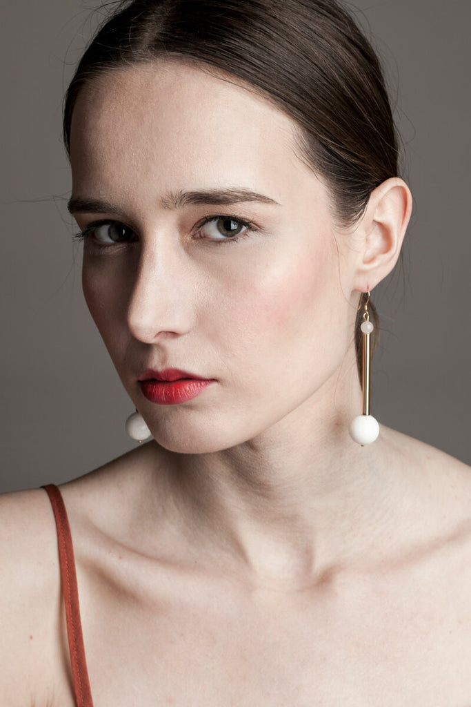 Earrings made of hand-cut, hand-polished and 24K gold-plated brass, white coral, rose quartz and gold plated sterling silver.