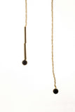 The piece features hand-cut and 24K gold-plated brass, onyx and 24K gold-plated chain.