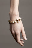 Bracelet features hand cut and 24K gold-plated brass and freshwater pearls.