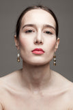 This mismatched earrings are made of hand cut and 24K gold-plated brass, freshwater pearls and gold-plated sterling silver.