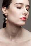 This mismatched earrings are made of hand cut and 24K gold-plated brass, freshwater pearls and gold-plated sterling silver.