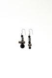 This mismatched earrings are made of hand cut and galvanized brass, onyx and sterling silver.
