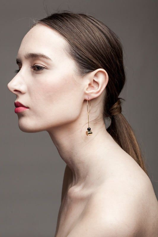 This pair of earring is made of a hoop earring which features 24K gold-plated brass and detachable pendant made of 24K gold-plated brass and onyx.