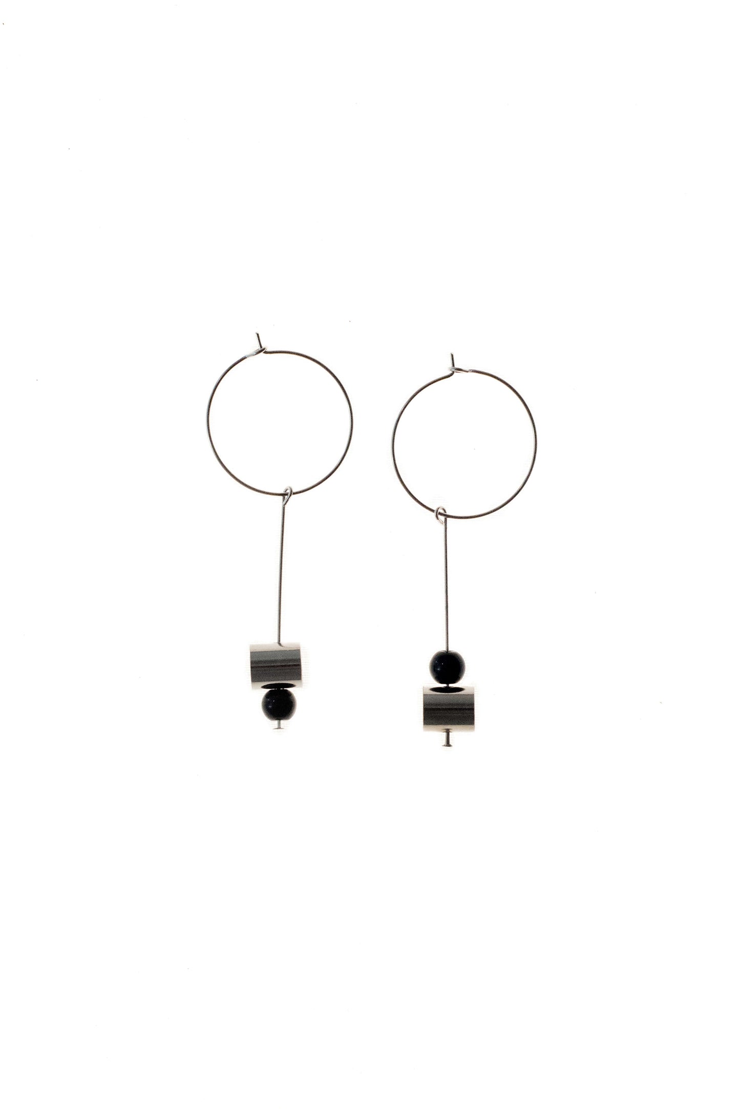 This pair of earring is made of a hoop earring which features galvanized brass and detachable pendant made of brass galvanized in silver and onyx.