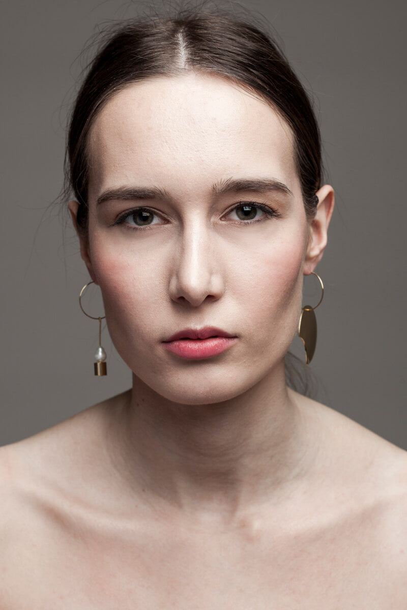 Earrings made of hand cut and 24K gold plated brass and freshwater pearl.