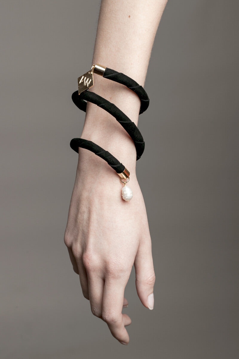 This sculptural cuff is made of finest sheep napa and 24K gold plated brass elements and freshwater pearls.
