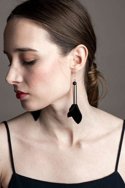 Earrings made of hand-cut leather, galvanized brass, onyx and sterling silver. 